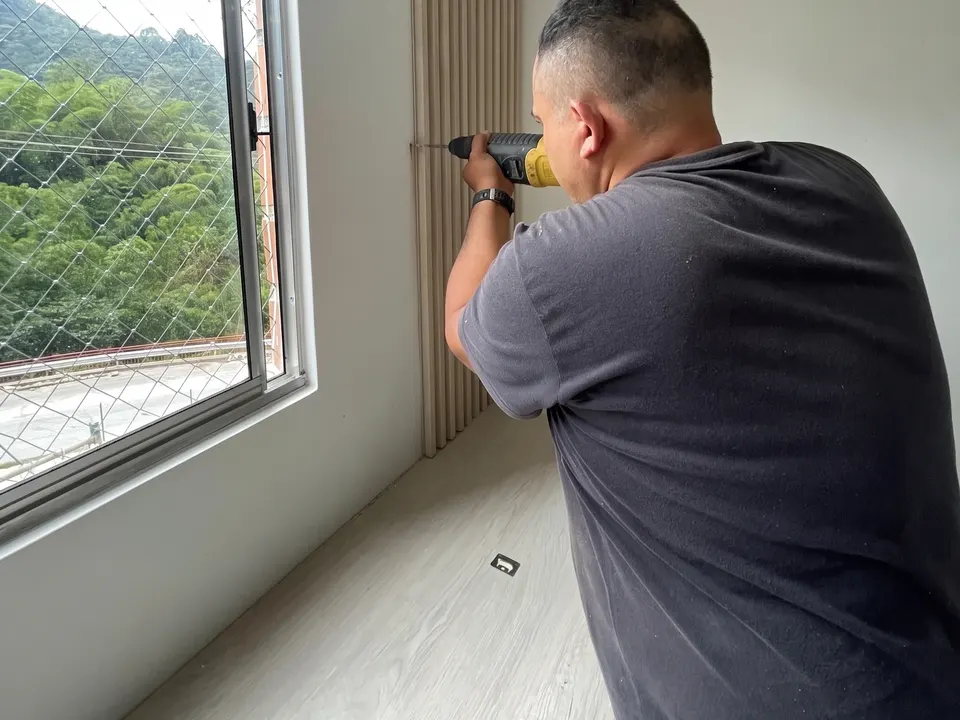 Instalación de un panel de listones de madera en casa del cliente